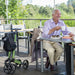 The Gemino 30 folded next to a gentleman enjoying a chat and cup light refreshments