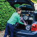 Woman easily loading the lightweight Rose Gold byACRE Carbon Overland rollator into a small car boot