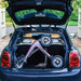The compact folded Rose Gold byACRE Carbon Overland rollator in the boot of a dark blue Mini Cooper