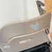 Close-up of the heart-shaped reflector on the padded backrest for the byACRE Carbon Ultralight rollator