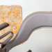The padded backrest for the byACRE Carbon Ultralight rollator seen from behind, showing its curved shape and breathable mesh