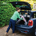 Woman easily loading the lightweight Pale Rose byACRE Carbon Ultralight rollator into a small car boot