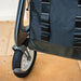 Front-on close-up of the byACRE Daypack bag on a byACRE rollator, showing its webbing straps and durable base