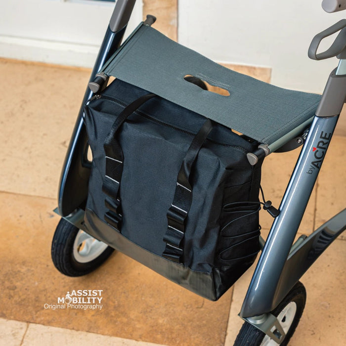 Looking down on the black byACRE Daypack bag attached beneath the seat of a byACRE Carbon Overland rollator