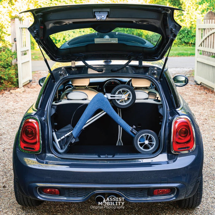 byACRE Nordic Pioneer rollator folded flat in the boot of a Mini hatchback, showing how compact it is for car travel