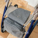 Overhead view of the grey byACRE Weekend Bag, its flap folded over the seat of a blue byACRE rollator