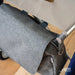 Close-up of the byACRE tag, strap loop and metal ring on the grey byACRE Weekend Bag where it clips to the rollator seat frame