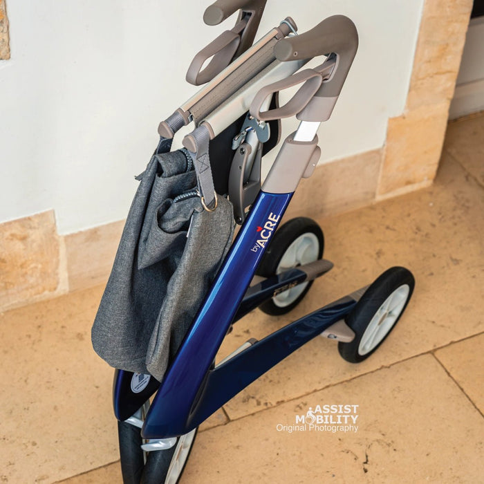 Close-up of the grey byACRE Weekend Bag hanging from a folded blue byACRE rollator, so there's no need to remove it before folding