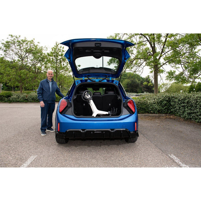 Gentleman next to small car with Rollator in the boot