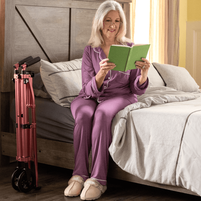 Lady sitting on the side of her bed with the EZ folded neatly by her side