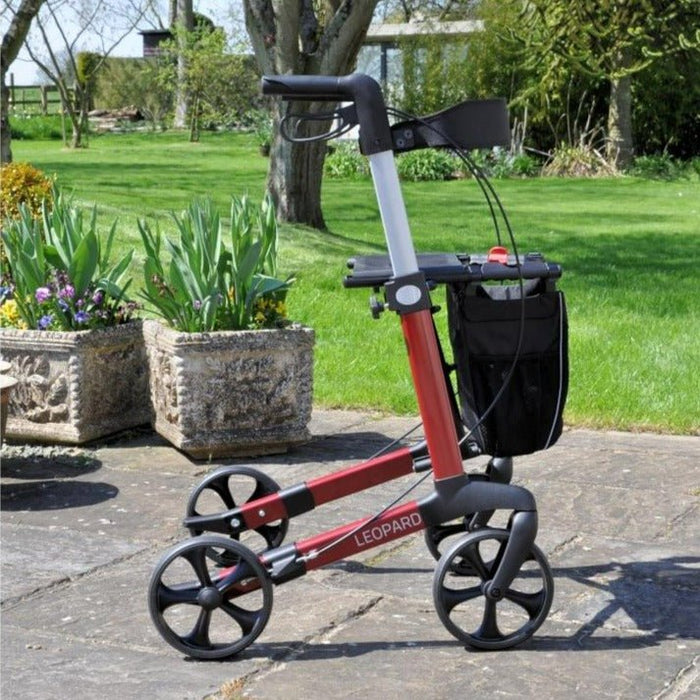 Mobilex Leopard rollator in red side view in a garden