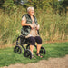 Lady resting on her Mobilex Puma Air rollator with air filled tyres for off road capacity