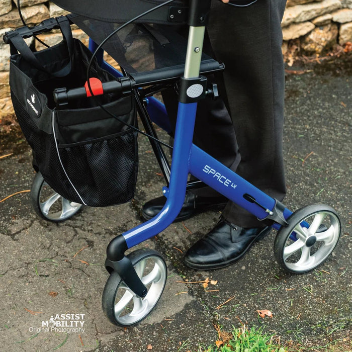 Close-up of the Electric Blue Rehasense Space LX rollator frame, showing the Space LX logo, side storage bag and large wheels
