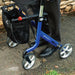 Close-up of the Electric Blue Rehasense Space LX rollator frame, showing the Space LX logo, side storage bag and large wheels