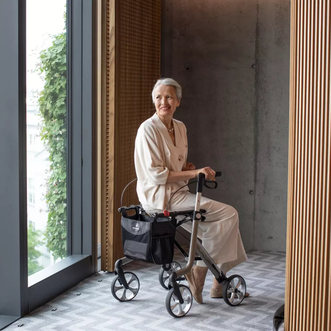 Lady sitting on her Rehasense Space LX rollator inside