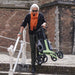 Lady lifting the Rollz Air Rollator in Mint Green down some stairs