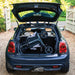 The compact folded Rollz Air Carbon Fibre rollator in the boot of a dark blue Mini Cooper