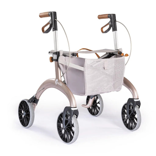 Saljol Carbon Superlight rollator in Rose Gold with a light grey mesh shopping bag and tan handles, on a white background