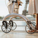 Low close-up of the wheels and frame of a Saljol Carbon Superlight rollator in Paris, with the Eiffel Tower in the background