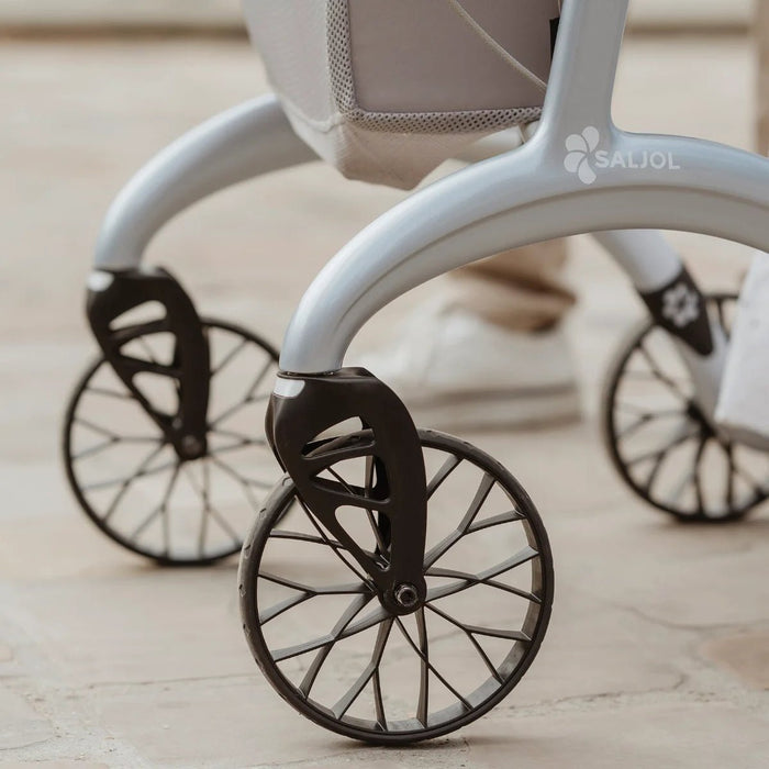 Close-up of the spoked wheels and curved frame with Saljol logo on the Saljol Carbon Superlight rollator