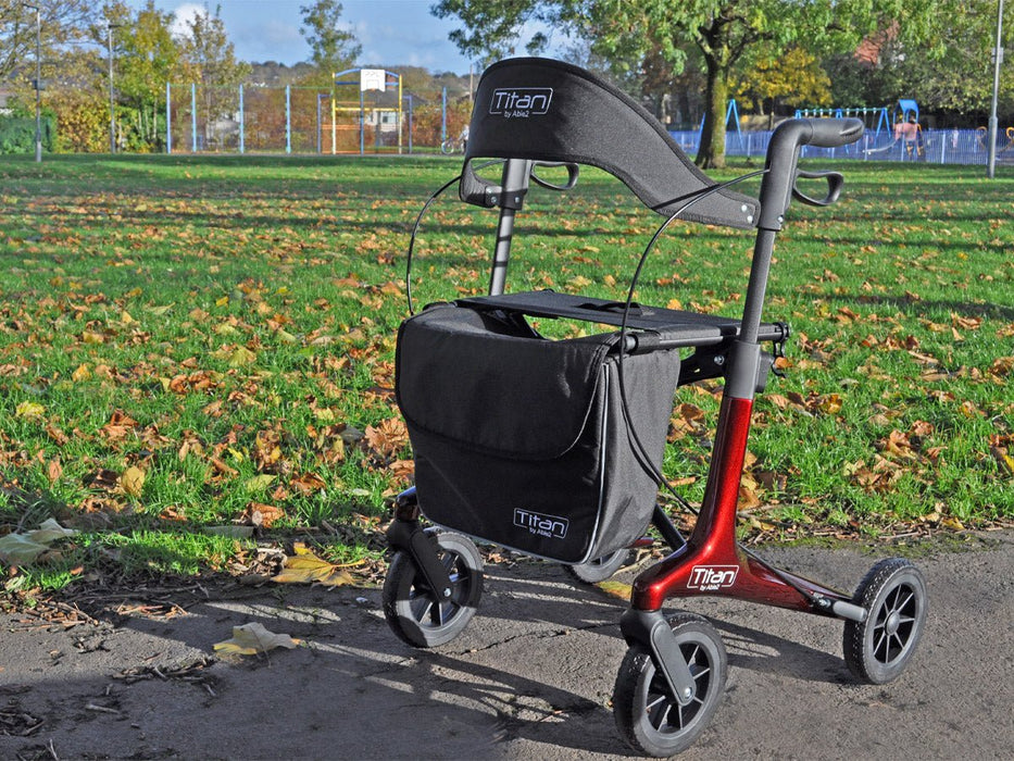 Titan carbon rollator in a park at Assist Mobility