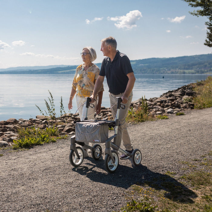 The Olympos ATR all terrain rollator being used along a coastal path on a beautifully sunny day