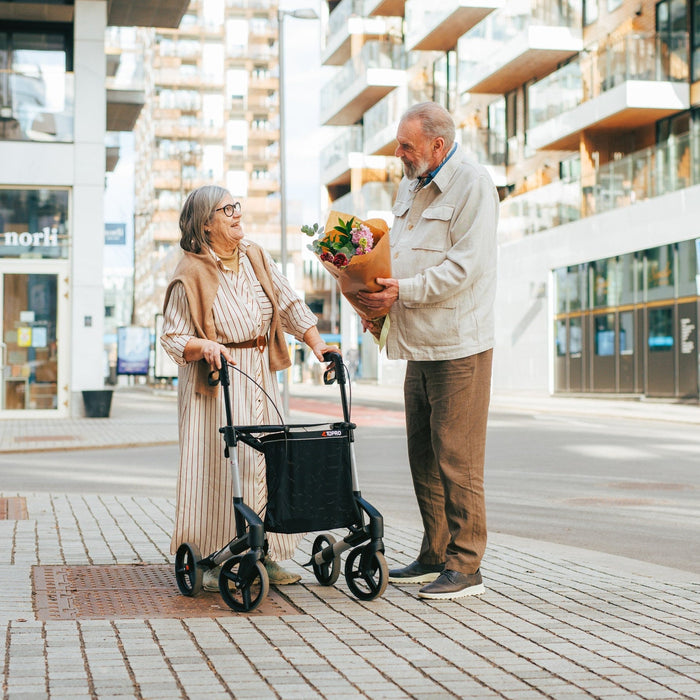 Two people chatting with the Topro Original Classic Rollator