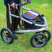 Close-up of the Trionic Veloped Sport frame on grass, showing the Trionic logo, chunky off-road tyres and striped storage bag