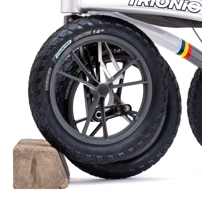 Close-up of a Trionic Veloped Walker with knobby tires on a white background