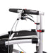 Close-up of a Trionic Walker handlebar with black grips and silver frame on a white background