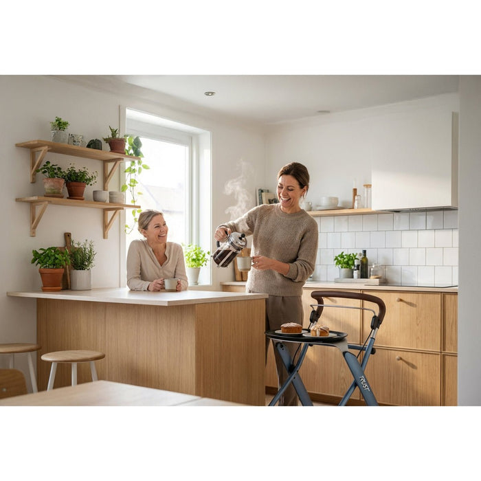 Two ladies in a kitchen using the Let's Dream tray to transport cakes to the table