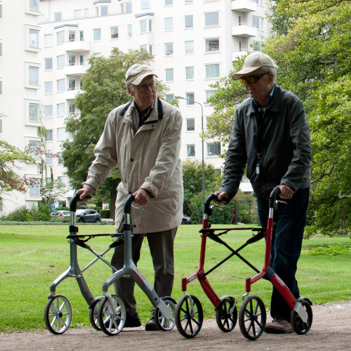 The two gentlemen walking along with their Trust Care Lets Fly rollators.