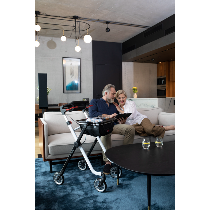 Couple relaxing at home with the Rehasense Space I indoor rollator