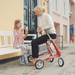 byAcre Carbon Ultralight rollator in Strawberry red grandchild and granny enjoying time together